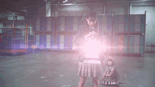 a girl in a plaid skirt is holding a glowing object in her hand