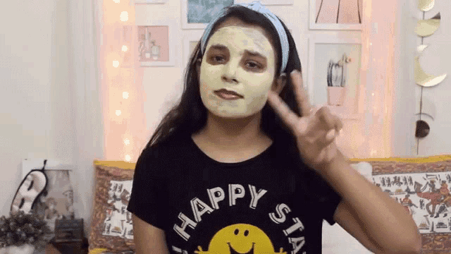 a girl with a mask on her face is wearing a shirt that says happy
