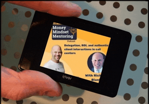 a person is holding a smart phone that says money mindset mentoring