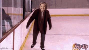 a woman is ice skating on a rink with gifbin.com at the bottom