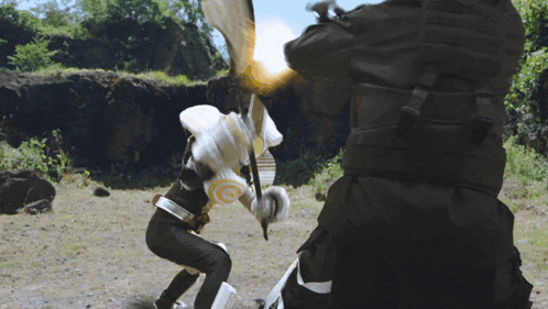 a man in a black suit is kicking another man