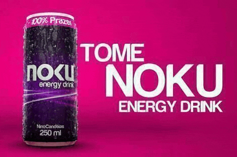 a can of tome noku energy drink is sitting on a pink surface .