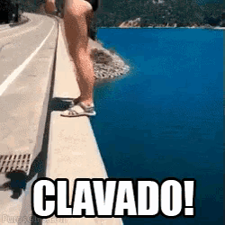 a woman is standing on a bridge overlooking a body of water with the words clavado written on the bottom