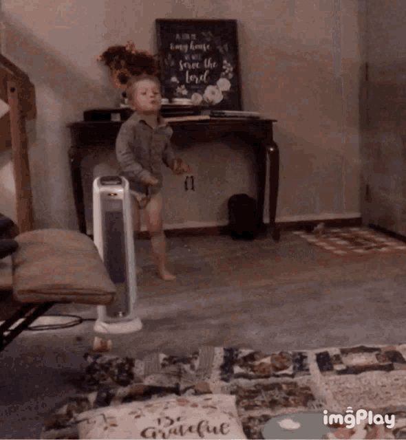 a little boy is standing in front of a sign that says " a happy home is a safe home "