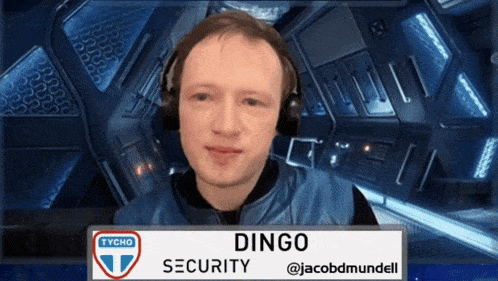 a man is wearing headphones and a sign that says dingo security