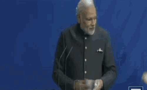 a man and a woman standing next to each other in front of an indian flag .