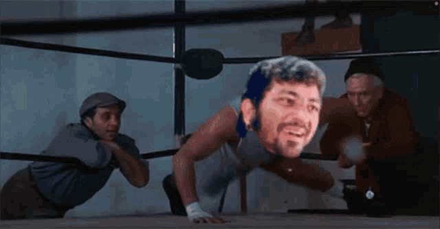 a man in a boxing ring with a picture of his face on his head