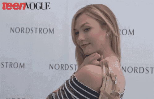 a woman standing in front of a nordstrom sign