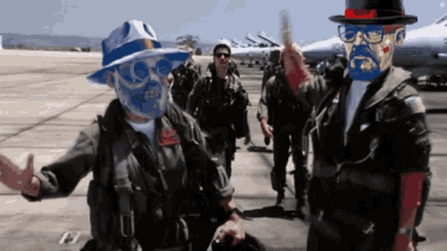 a group of soldiers are standing on a runway and one of them has a mask on