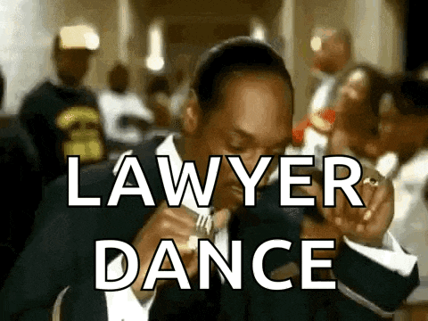 a man in a suit and tie is eating a piece of food with the words `` lawyer dance '' behind him .