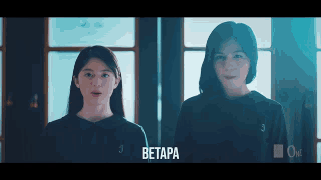 two girls are standing next to each other and the word betapa is on the bottom