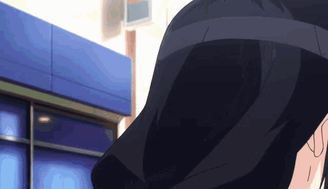 a person in a black jacket is standing in front of a store