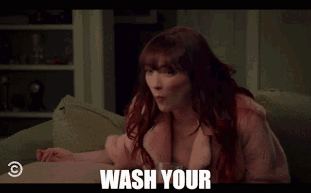 a woman with red hair is sitting on a couch with the words fuckin hands on the bottom