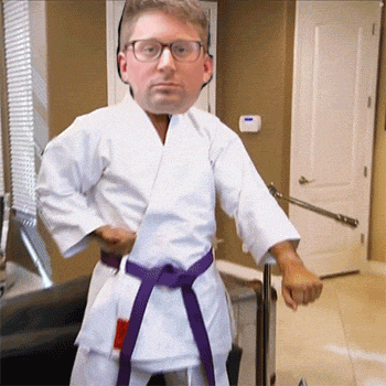 a man in a white karate uniform with a purple belt and glasses