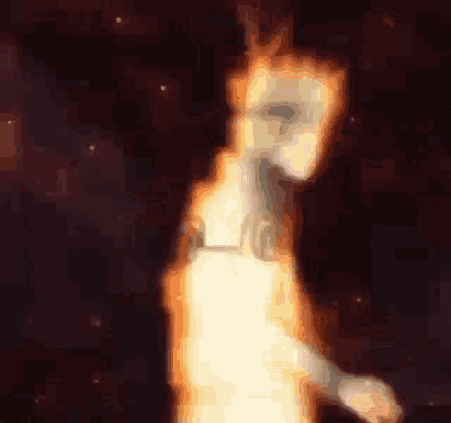 a blurred image of a person 's face with a flame coming out of it 's mouth