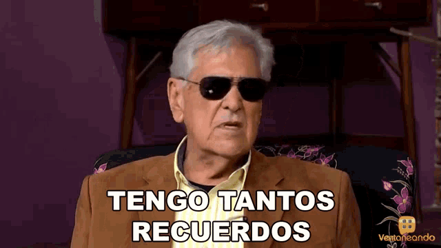 a man wearing sunglasses and a suit says tengo tantos recuerdos