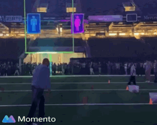 a man kneeling on a football field with the word momento on the bottom right