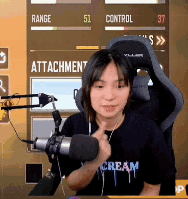 a woman wearing a cream t-shirt is playing a video game