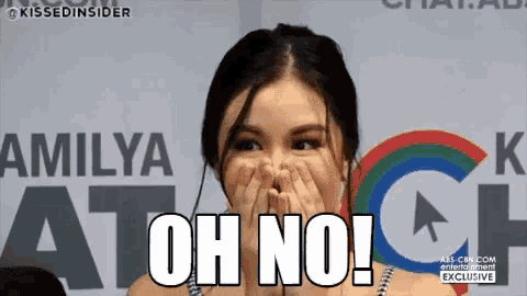 a woman is covering her mouth with her hands and says oh no .