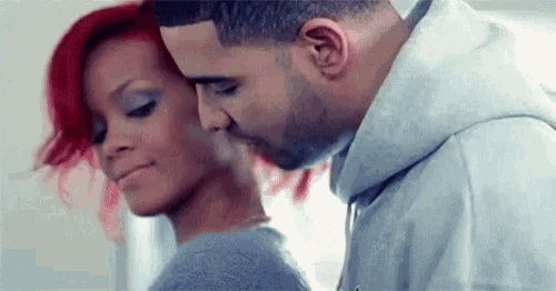 a man with a beard is kissing a woman on the forehead .