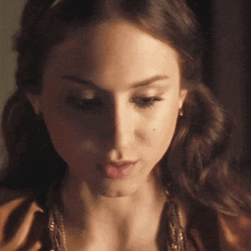 a close up of a woman 's face with her eyes closed