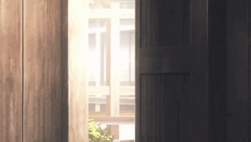 the sun is shining through a window in a wooden room .