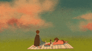 a man and a woman are laying on a blanket in the grass