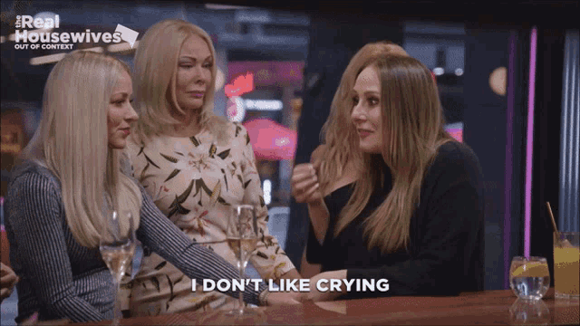 a group of women are sitting at a bar and one of them is saying " i don t like crying "