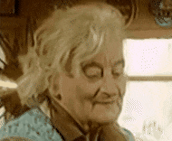 an elderly woman with her eyes closed and her hand on her chin .