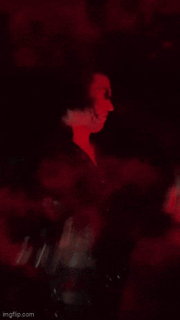 a blurry picture of a person with a red light behind them .