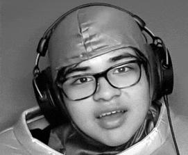 a black and white photo of a young man wearing glasses and headphones .