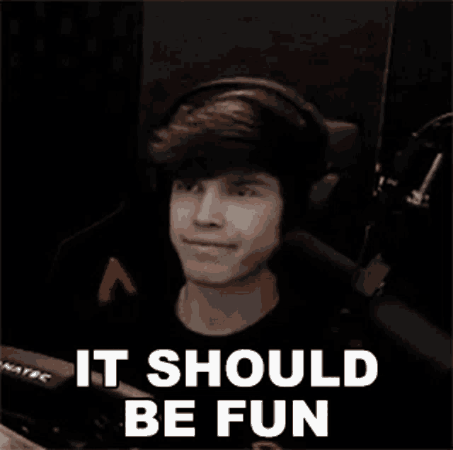 a man wearing headphones is sitting in front of a microphone with the words `` it should be fun '' .