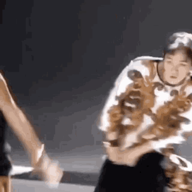 a man and a woman are dancing together on a stage in a dark room .