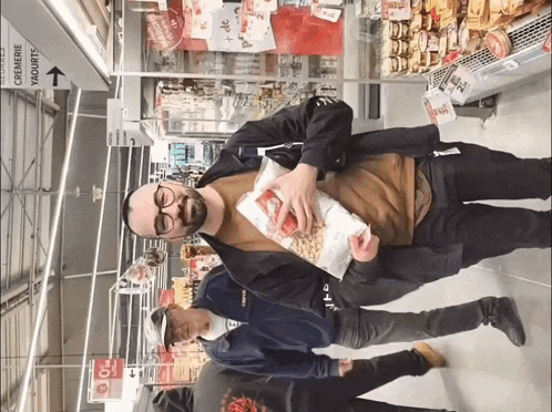 a man holding a bag of food in a store with an arrow pointing to the corner of the store