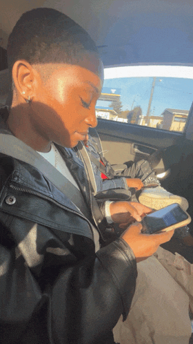 a person in a car looking at their cell phone