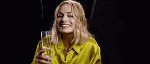 Margot Robbie Champagne GIF - Margot Robbie Champagne Shrug GIFs