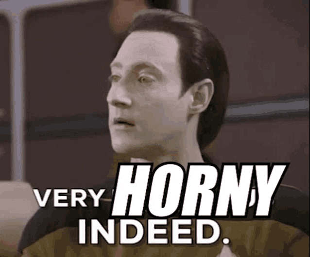 a man is sitting in front of a sign that says `` very horny indeed '' .