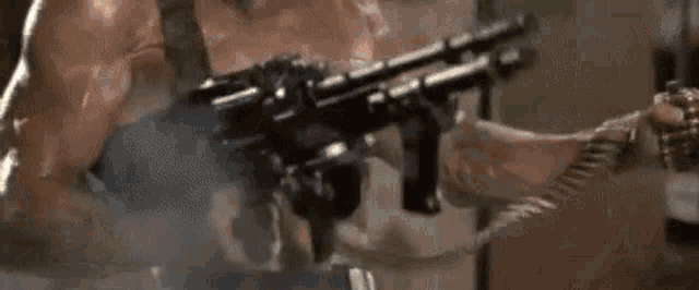 a woman is holding a gun with a blurred background
