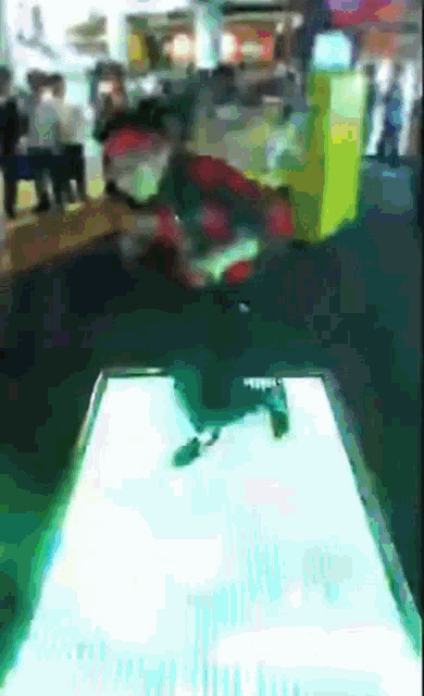 a blurred image of a person standing on a table with a yellow box in the background