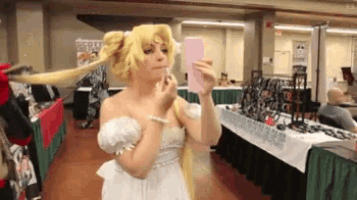 a woman in a white dress is taking a selfie with her phone