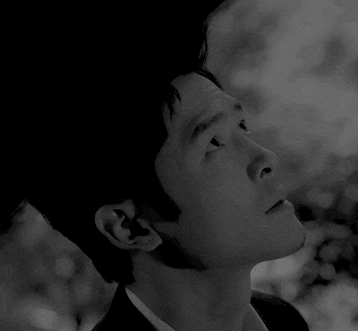 a close up of a man 's face with his eyes closed