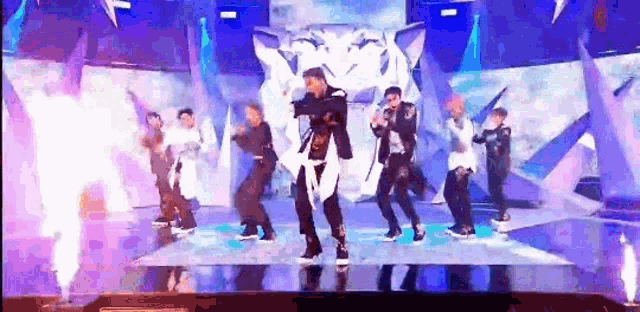 a group of people are dancing on a stage in front of a tiger .