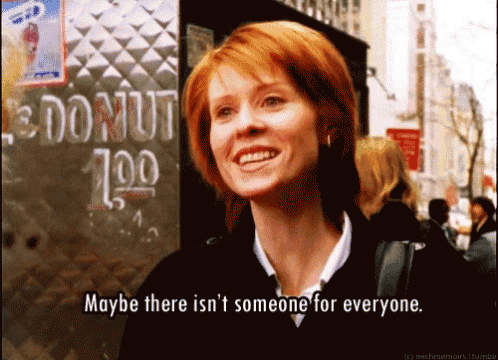 a woman is smiling in front of a donut sign