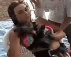 a woman is being rescued from the water by a man .