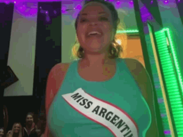 a woman is wearing a miss argentina sash around her neck