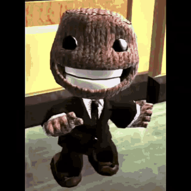 a stuffed animal wearing a suit and tie is smiling