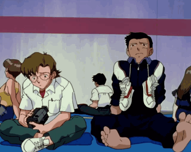 a man sits on the floor with his feet crossed while holding a pair of shoes
