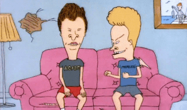 two cartoon characters are sitting on a pink couch one is wearing a shirt that says acxbc