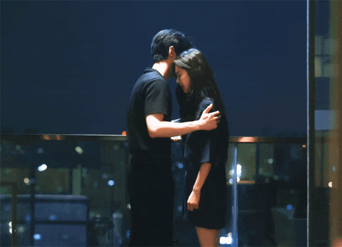 a man and a woman are hugging each other in front of a window with a sign that says pod