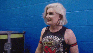 a woman wearing a tank top that says well on it